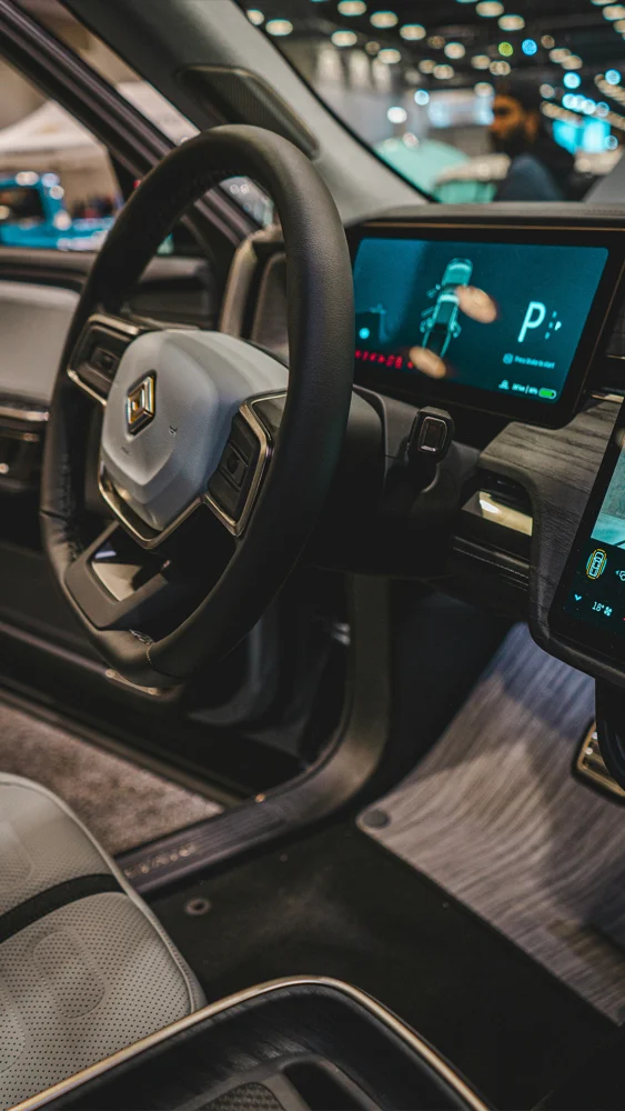 Interior dashboard and steering wheel of Rivian R1T electric truck with digital display