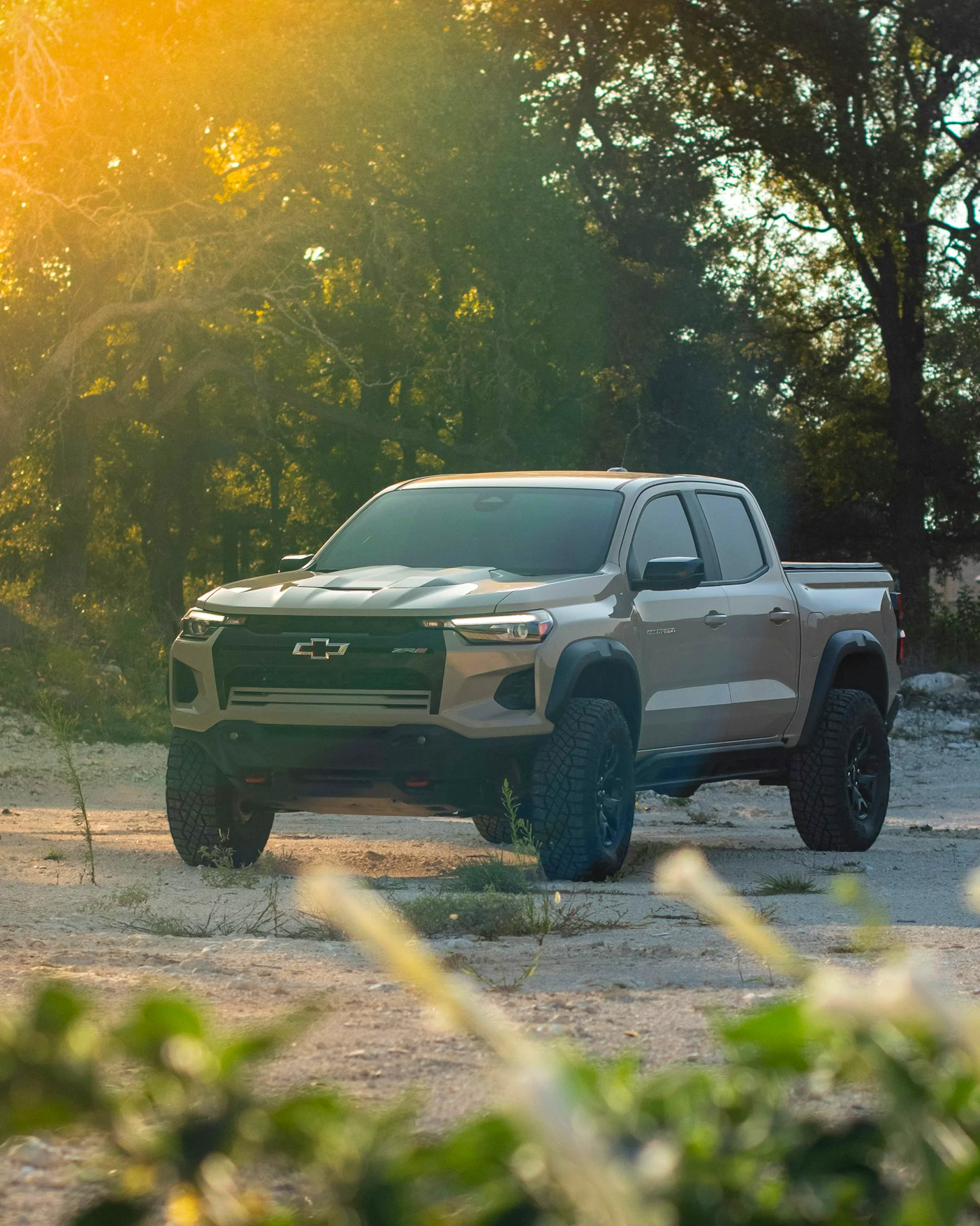Chevrolet Colorado pickup truck parked off-road with sunlight in the background