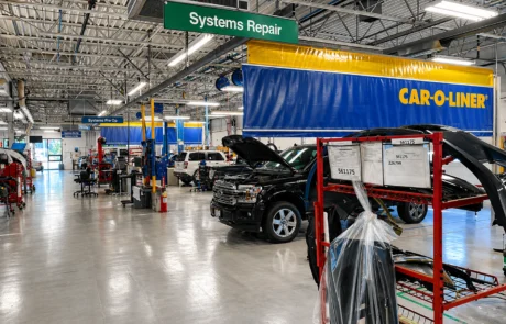 Collision repair production floor with systems repair area and Car-O-Liner structural workstations