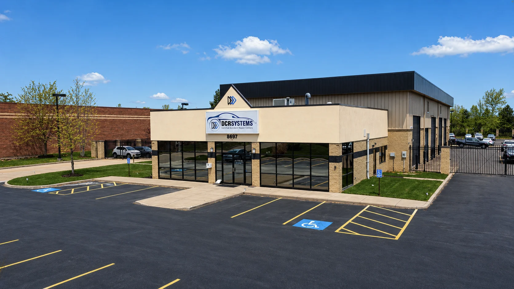 Front elevation of DCR Systems Mentor collision repair facility with customer parking area