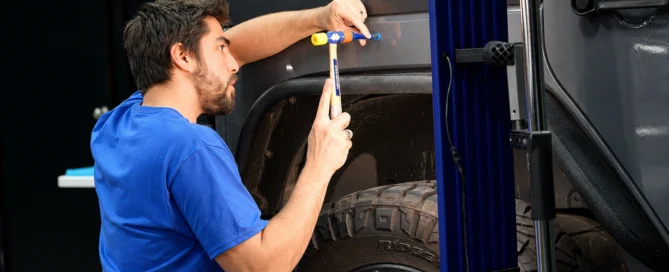 Technician performing auto body panel repair in Mentor, Ohio collision repair facility
