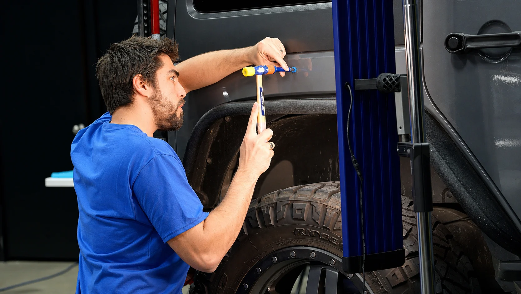 Technician performing auto body panel repair in Mentor, Ohio collision repair facility
