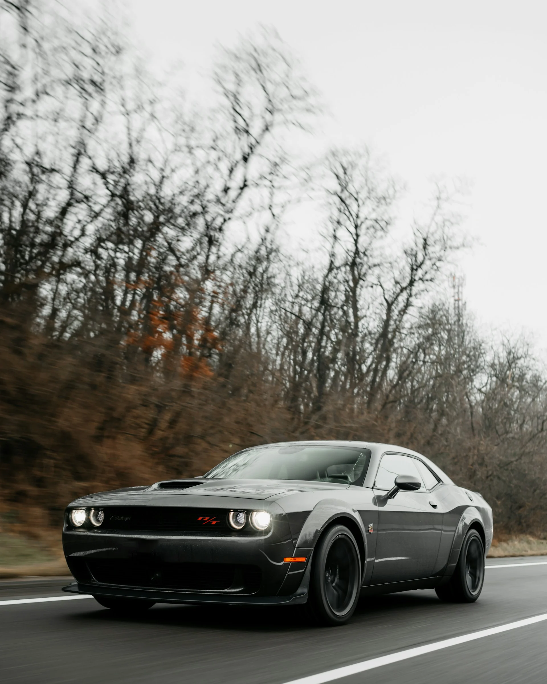 Dodge Challenger driving on road with motion blur