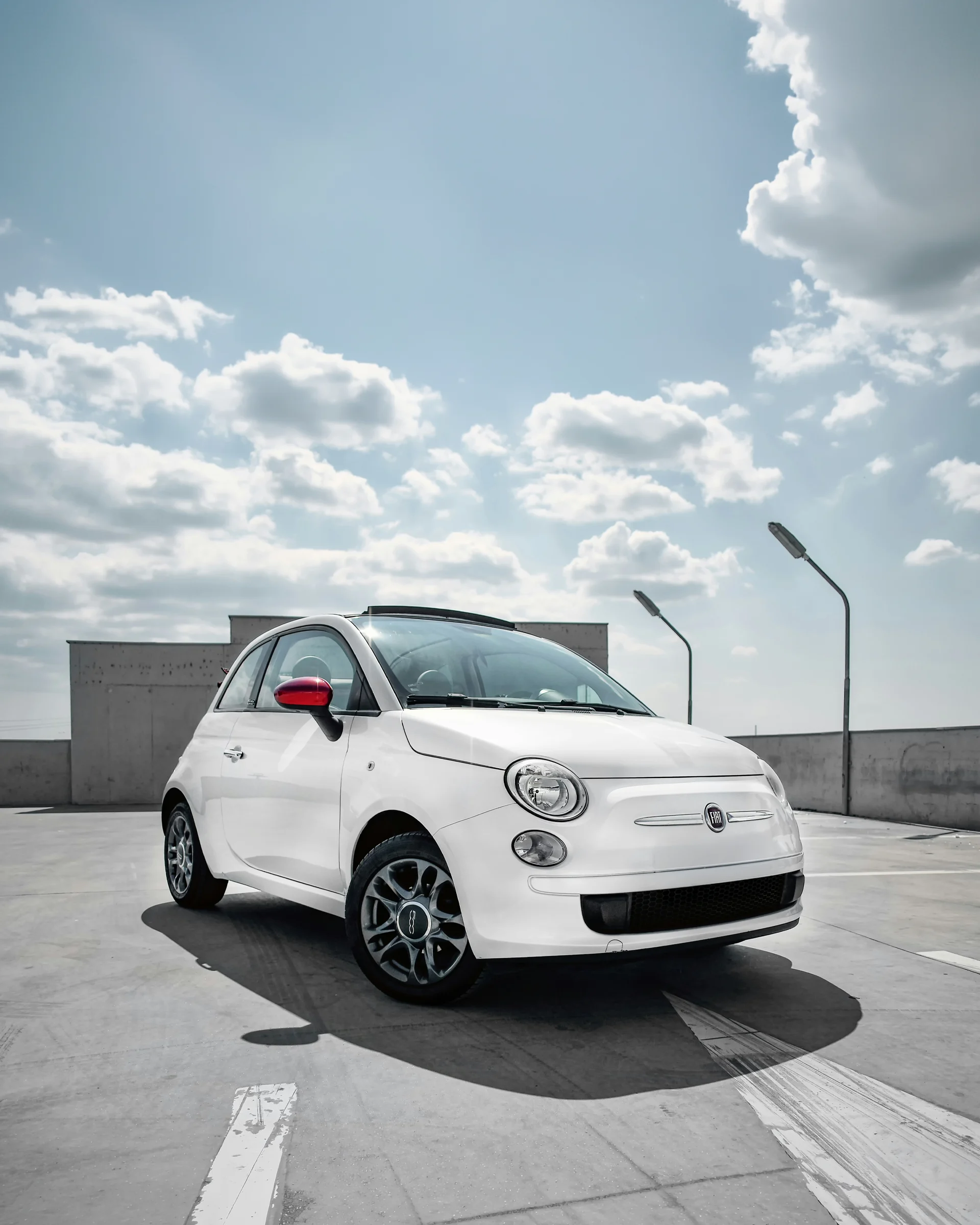 White Fiat 500 compact car parked on rooftop
