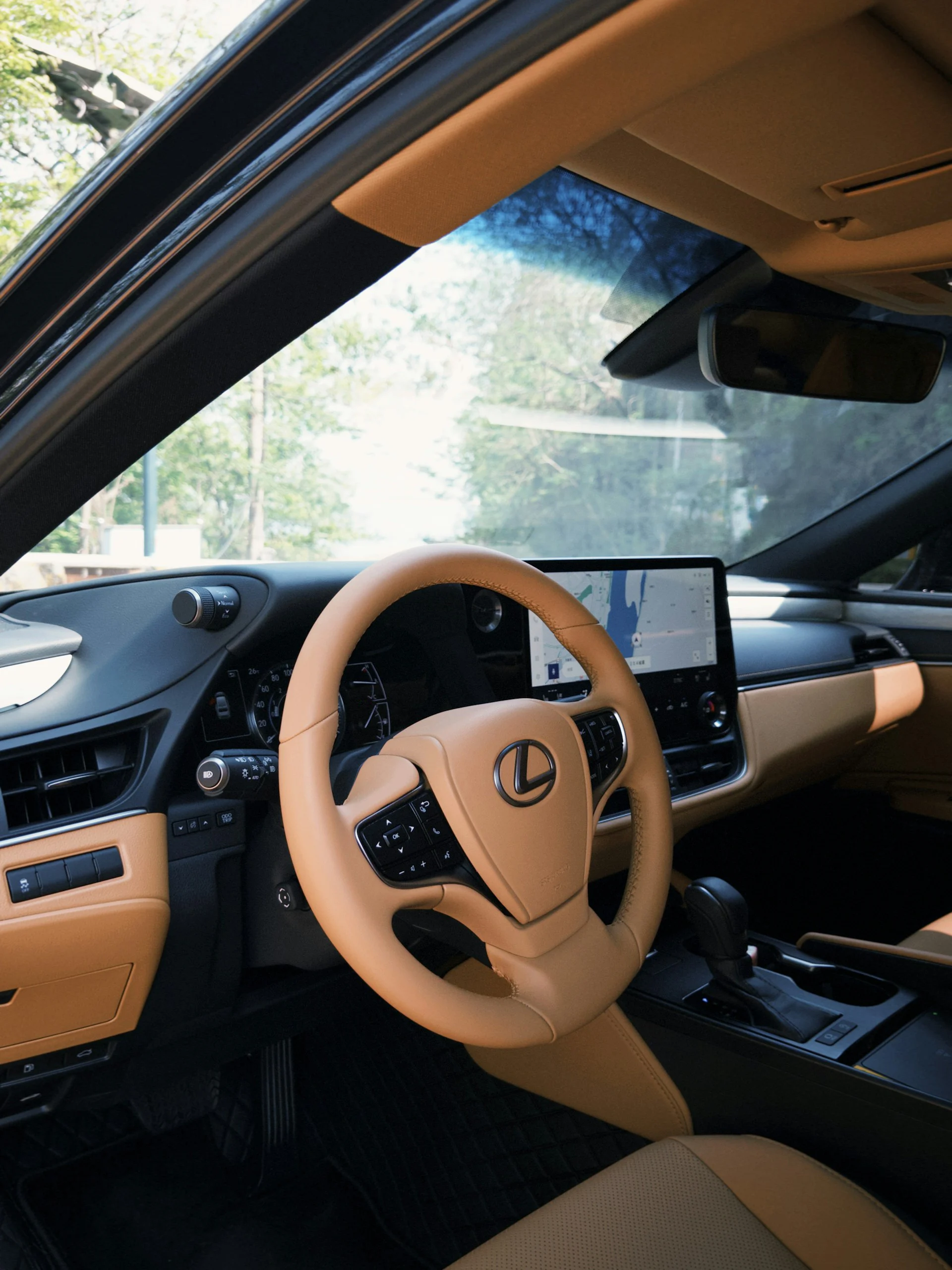 Lexus interior showing steering wheel, dashboard, and center display
