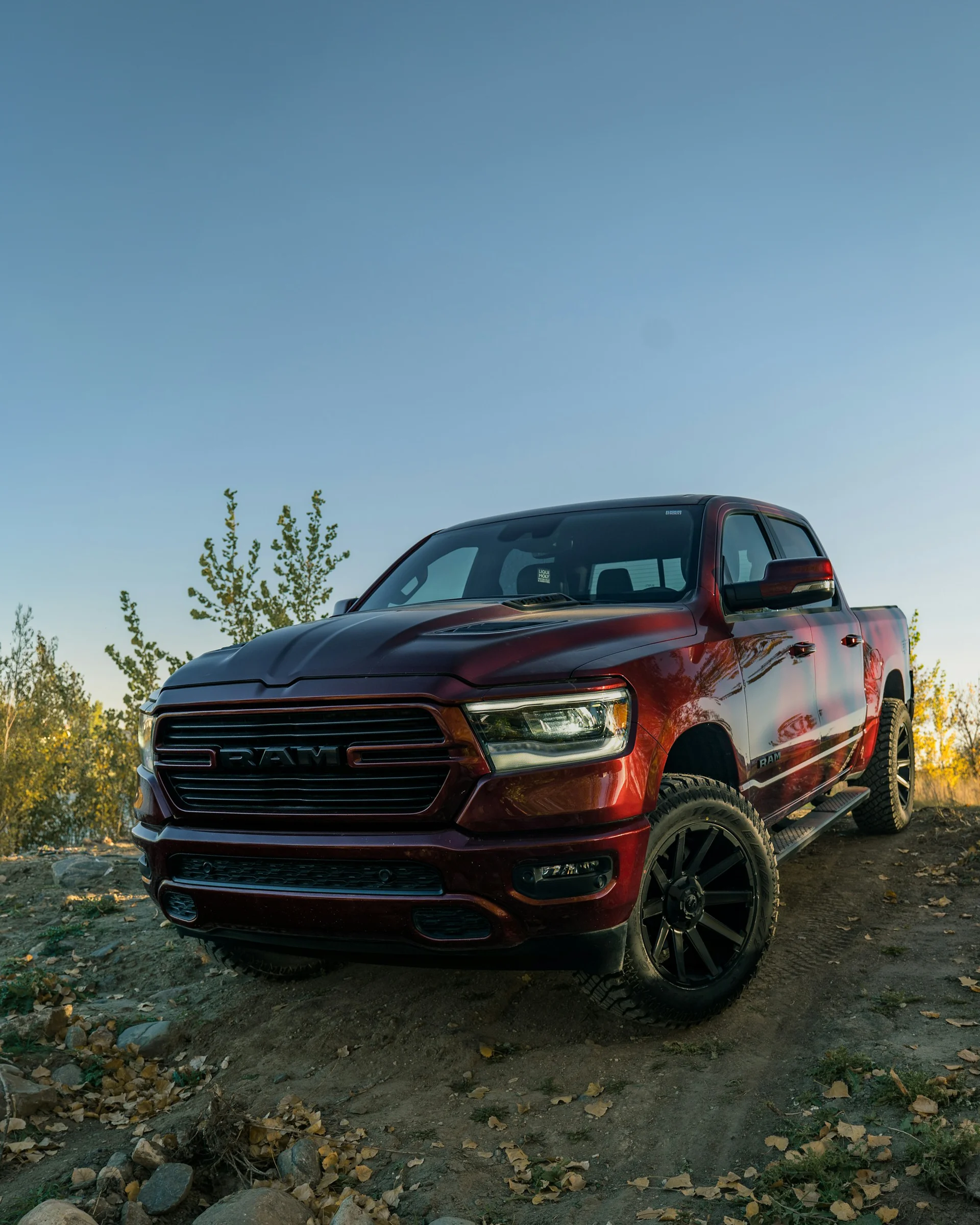 RAM truck driving up rocky off road hill