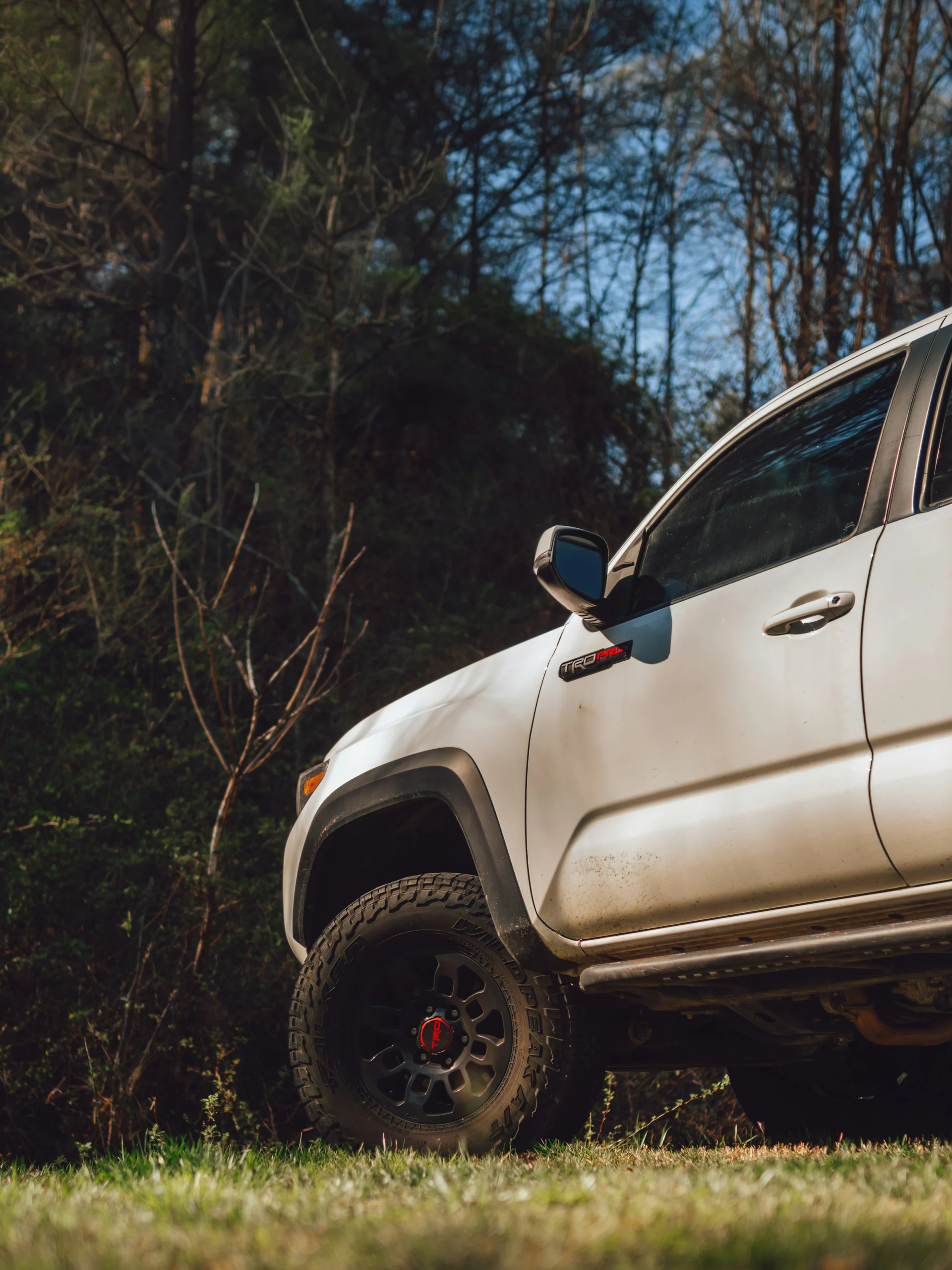 Toyota Tacoma TRD Pro off-road truck parked on grass with rugged tires and trail-ready suspension