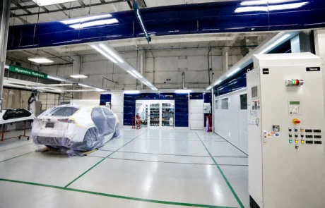 Masked vehicle in refinishing prep area at DCR Systems Mentor collision repair facility