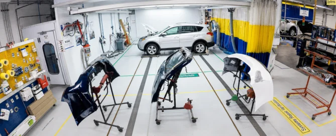 Automotive bumper panels staged for refinishing and paint preparation at DCR Systems Mentor collision repair facility